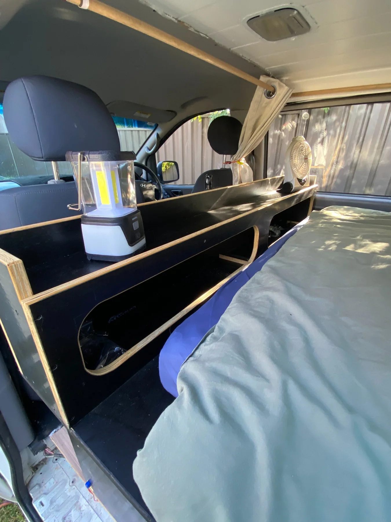 Internal bedside storage in camper van conversion